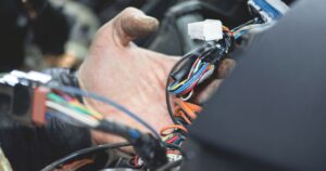 Mechanic holding auto wiring